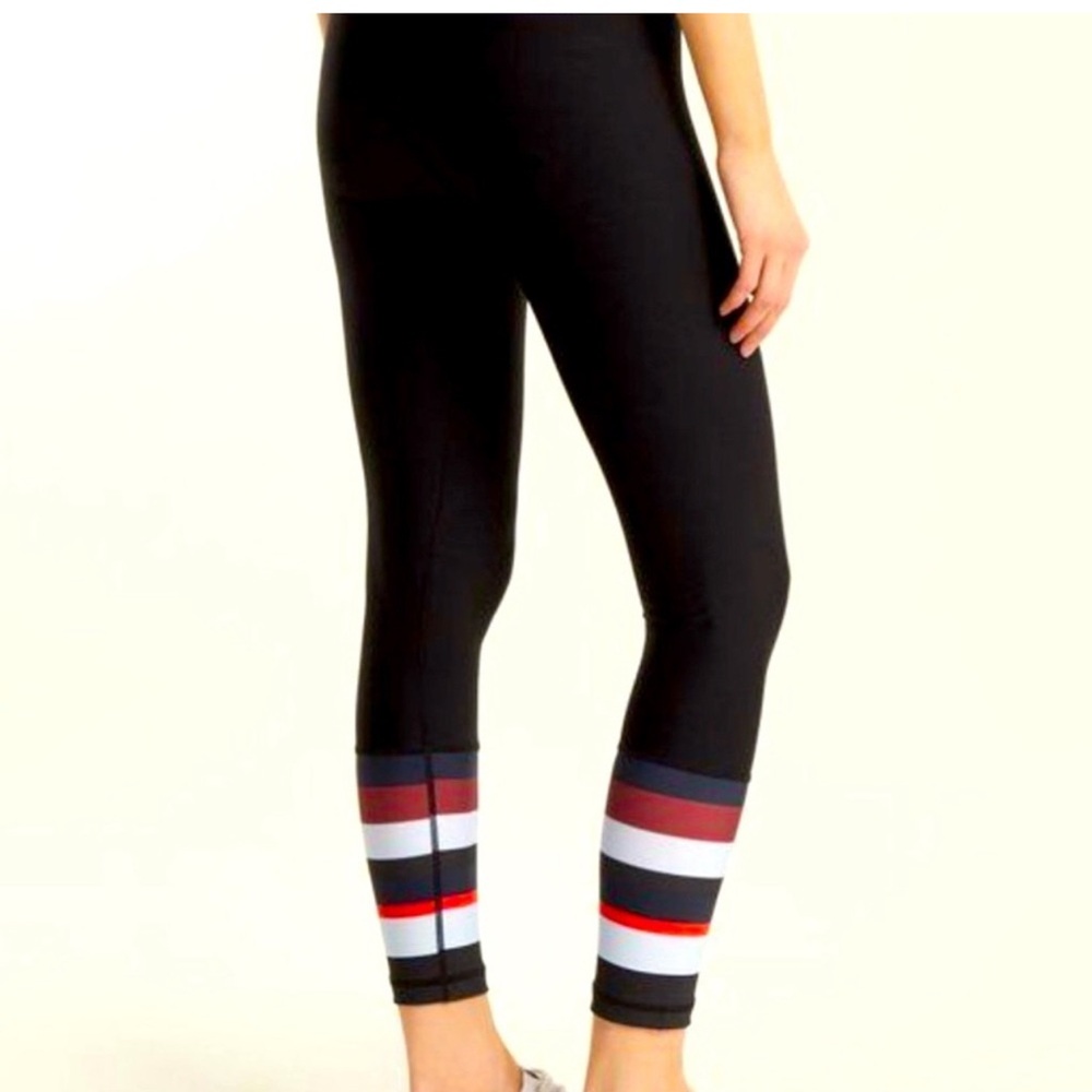 The Upside Black Mid Rise Leggings with red and white Striped Detail. Size 8